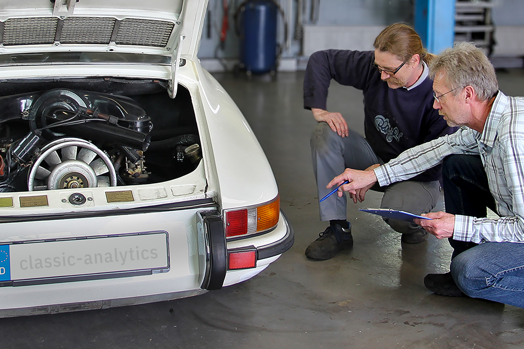 father and son repairing a car